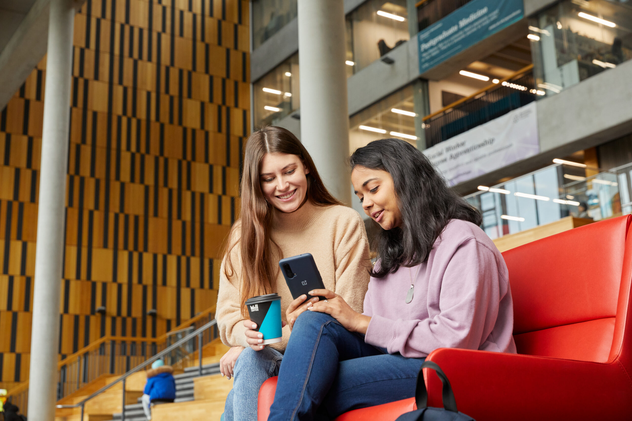 students-looking-at-phones-in-brooks-35560991 Students looking at their phones