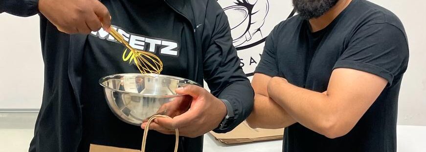 Youtuber Michael Shublacker whisks at Cheetham's artisan baking business