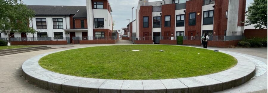 Centre point of Maine Road - a circle of grass in the middle of a street.