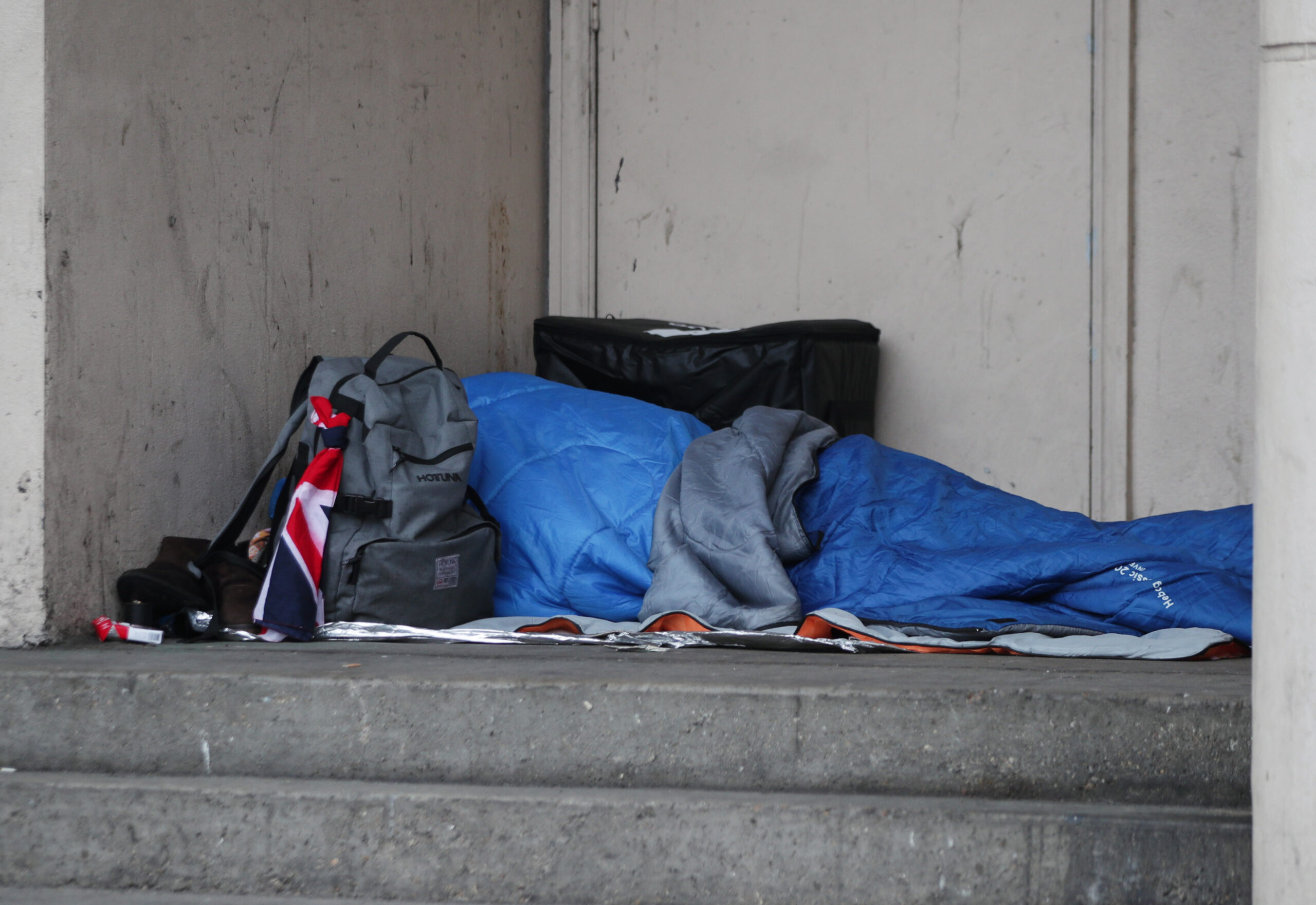 Rough sleeper on steps. Photo Credit: Yui Mok/PA Wire